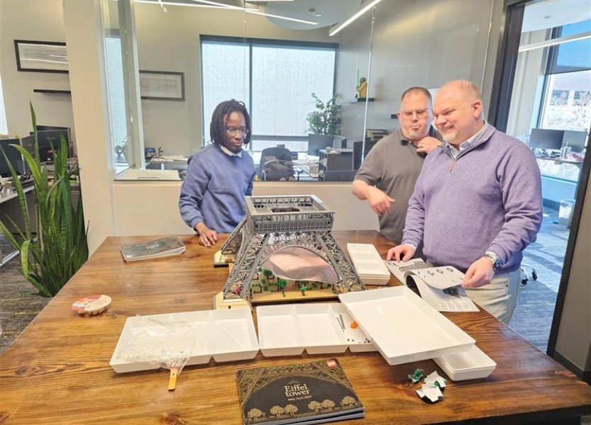 Orsborn team members building a Lego model of the Eiffel Tower